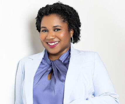 bria-johnson-personal-stylist-bio-portrait.jpg Bria Johnson smiling in a light blue suit during her I.C.O.N.I.C With Style bio portrait session.