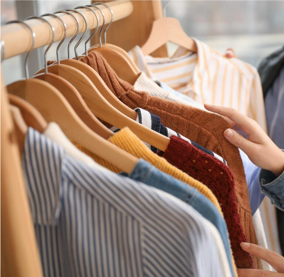 the-iconic-image-personal-brand-advisor-wardrobe.jpg Hand browsing a curated wardrobe during the Personal Brand Advisor phase.
