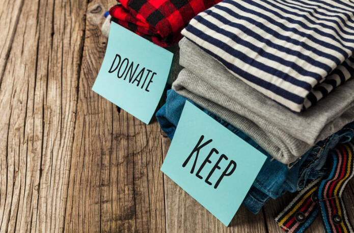iconically-ready-wardrobe-reclamation-donate-keep.jpg Stacked clothing labeled “donate” and “keep” for the Virtual Wardrobe Reclamation process.